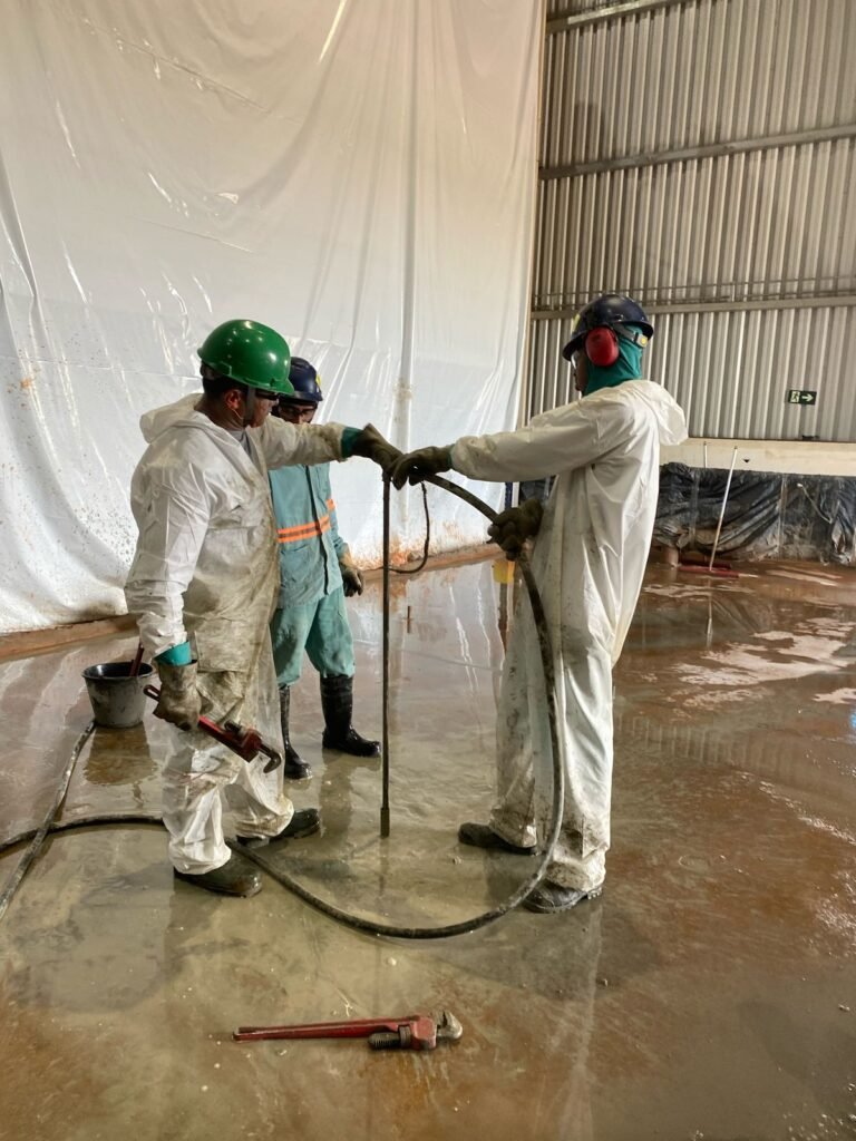 Equipe da SCO executando injeção de consolidação para reforço de solo no interior de edificação